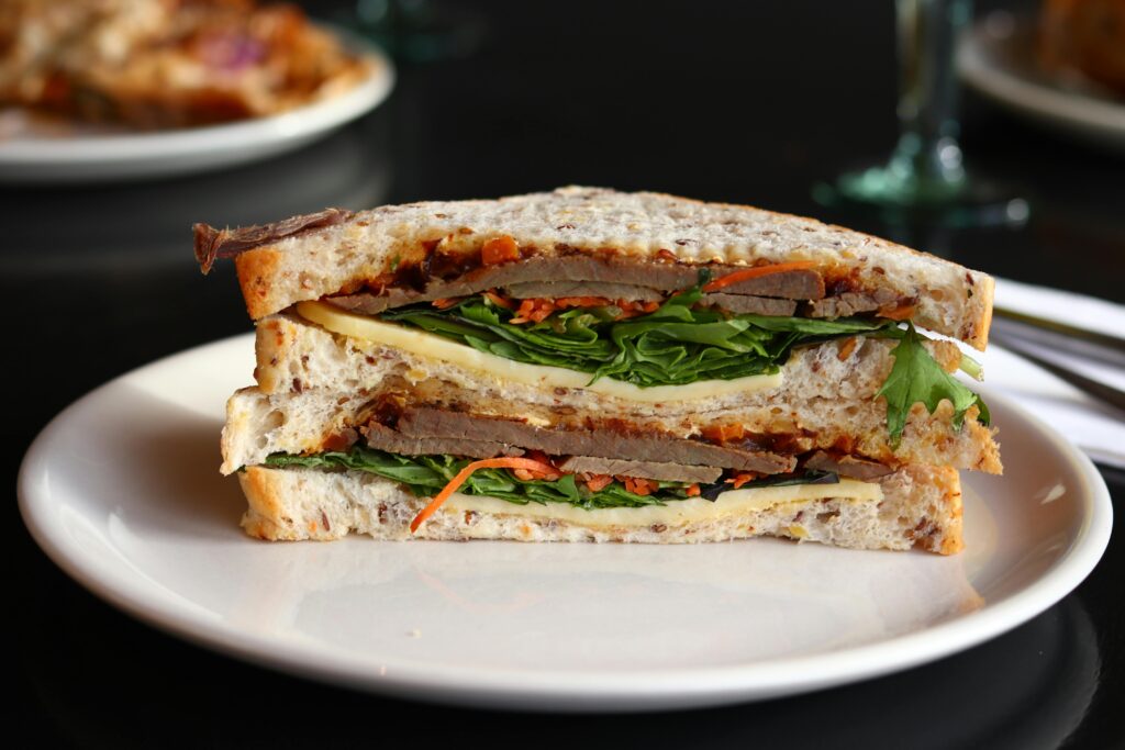 Close-up of a hearty sandwich with fresh ingredients, ready to enjoy.